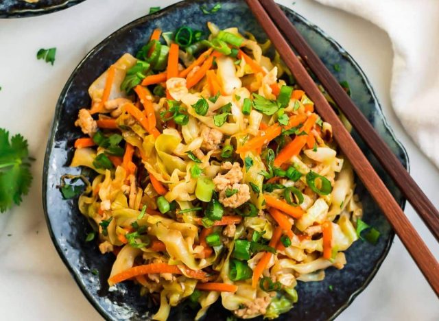 plate of cabbage stir fry and chopsticks