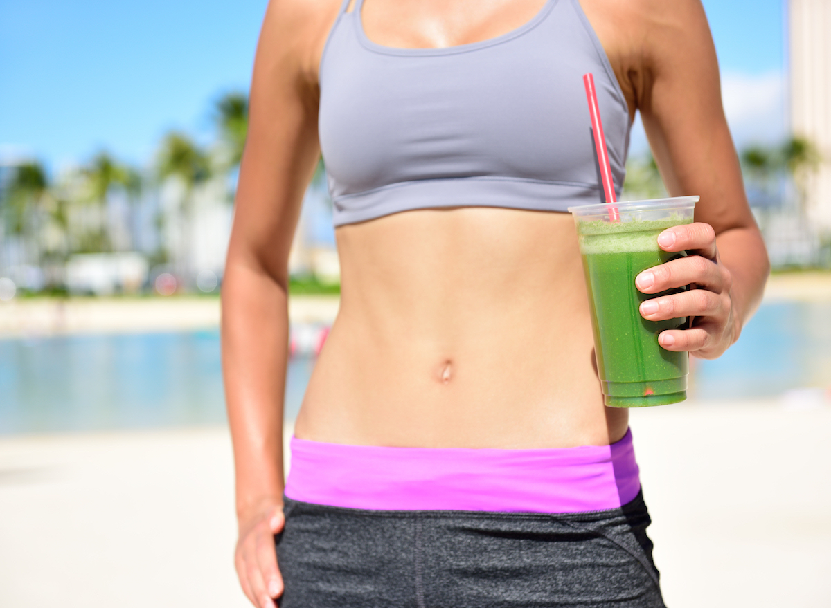 Woman holding green smoothie