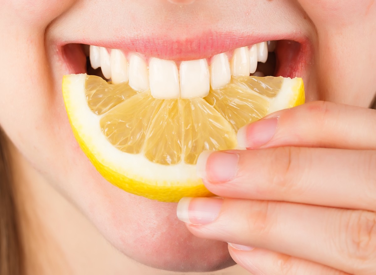 teeth biting into lemon