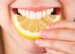 teeth biting into lemon