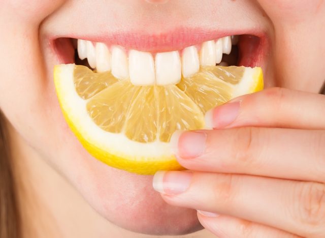 teeth biting a lemon
