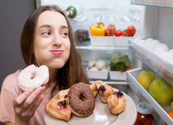 Woman eating sugary junk food