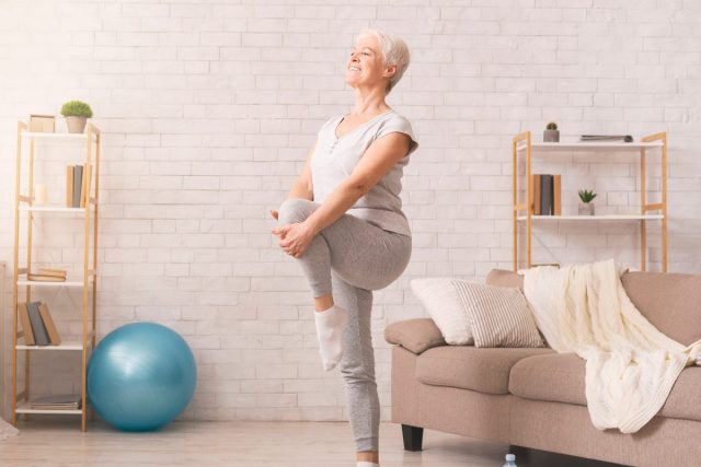 senior woman doing balance training at home