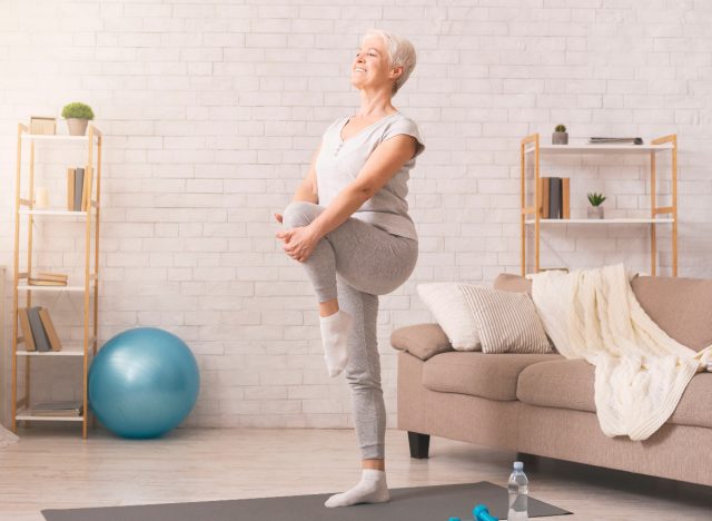 senior woman doing balance training at home