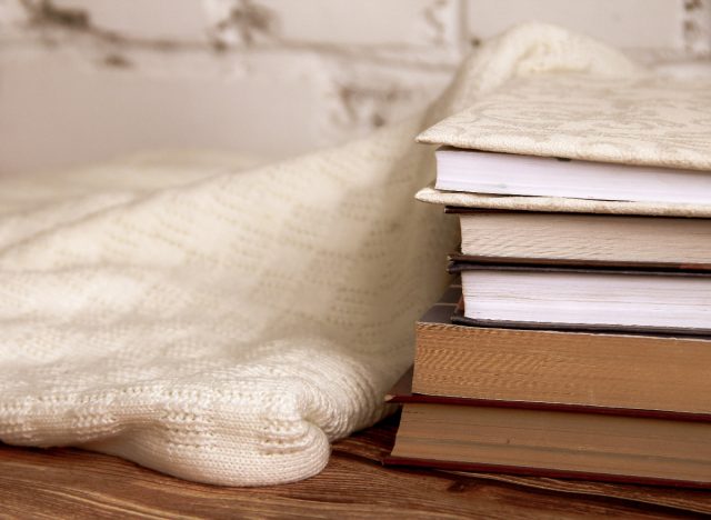 books stacked in bedroom for nighttime reading