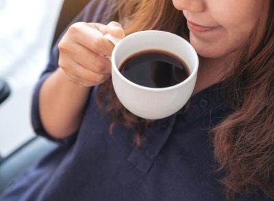 woman drinking black coffee