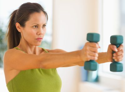 woman doing dumbbell workout to get rid of bat arms