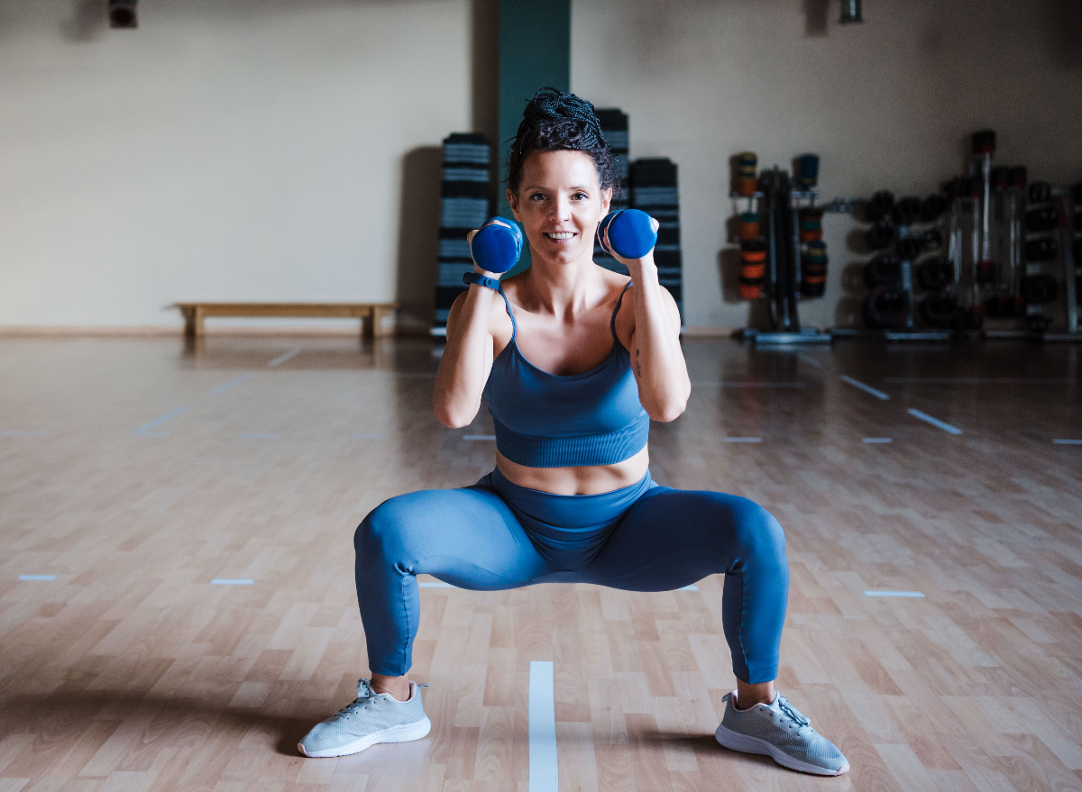 young woman performing dumbbell goblet squat to get rid of thigh fat