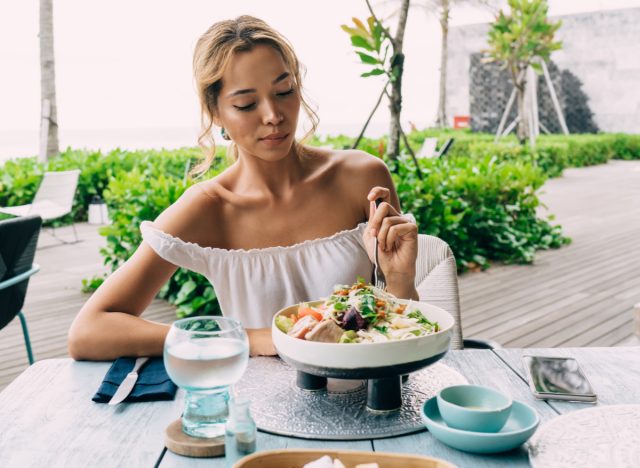 woman eating healthy salad, secrets about adding years to your life