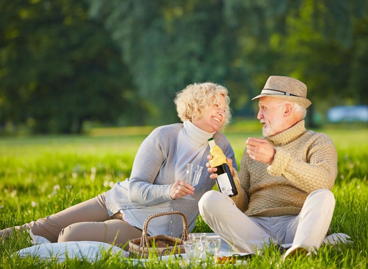 elderly couple drinking wine