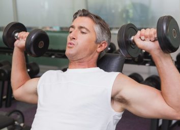 fit mature man doing dumbbells workout