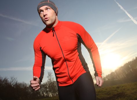 fit man in red outfit exercising outside