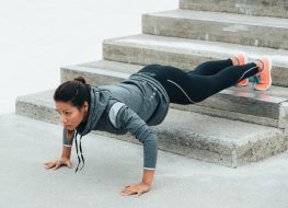 fit woman doing elevated pushup to break the plateau and lose weight
