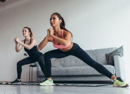 two fit women doing quickie workout, cardio at home