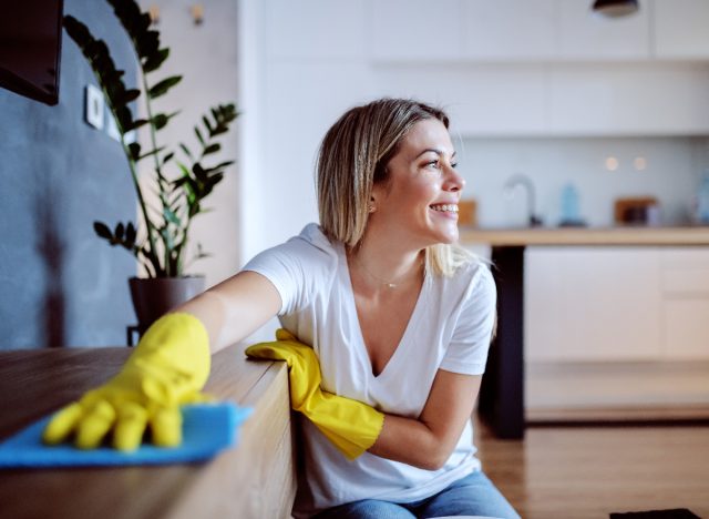 happy woman cleaning bright home