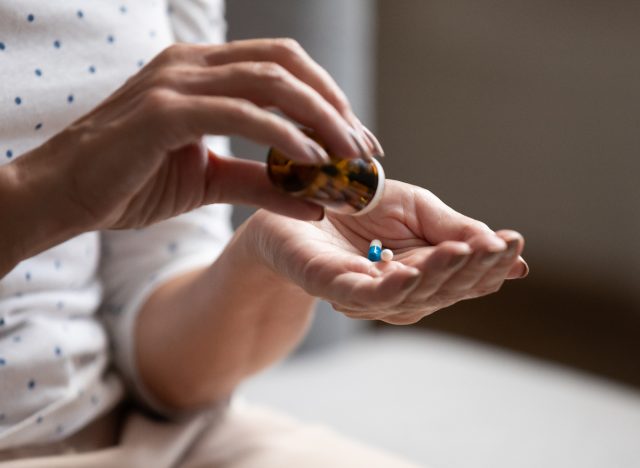 closeup woman taking high blood pressure medication