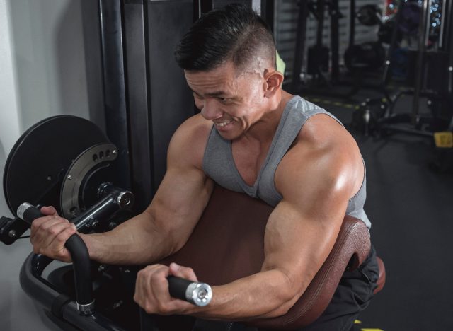 man performing bicep curls in gym