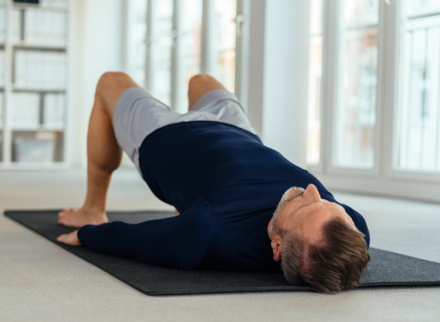 man with bad back in his 40s performing bridge exercise