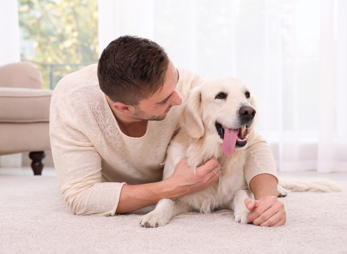 man cuddles with dog, baby talk talking to pup