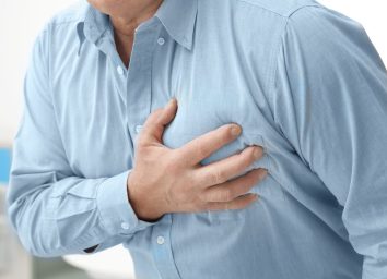man dealing with chest pain, heart disease