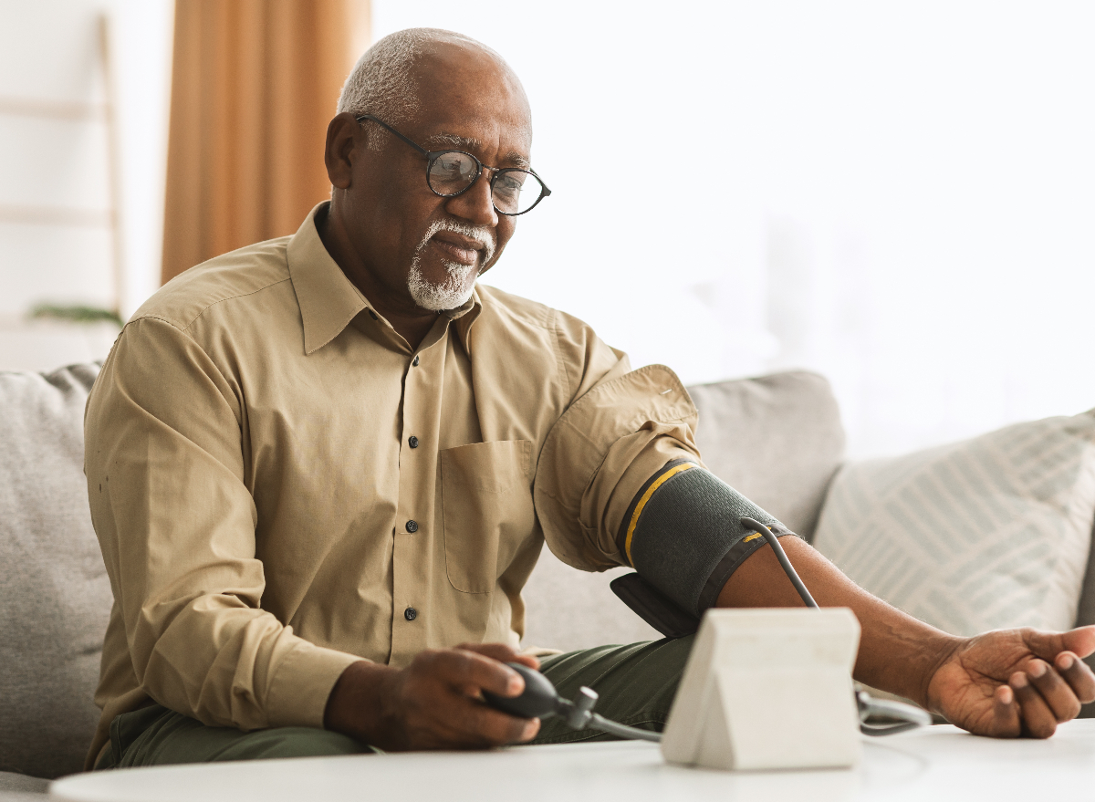 man dealing with high blood pressure, measuring it at home