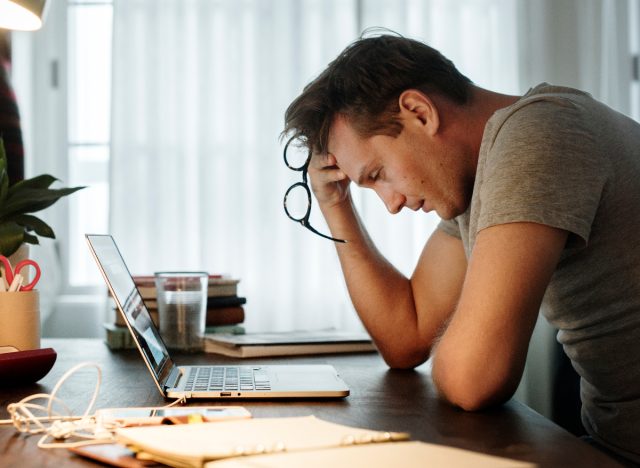 man experiencing high stress doing work, panic attack