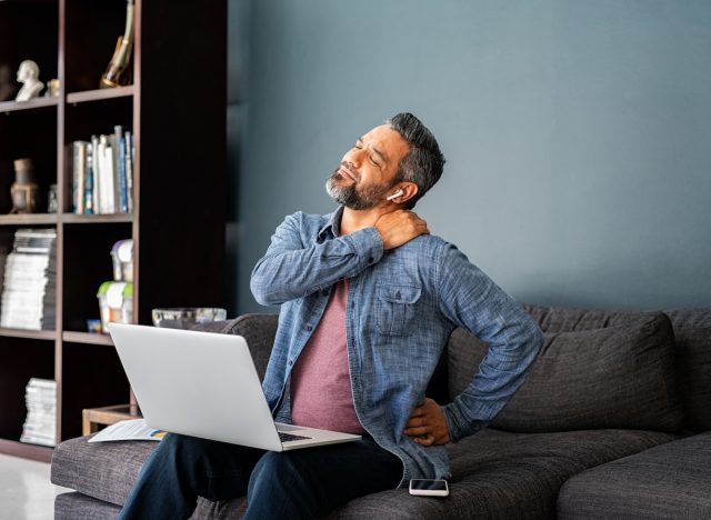 man experiencing muscle and back pain