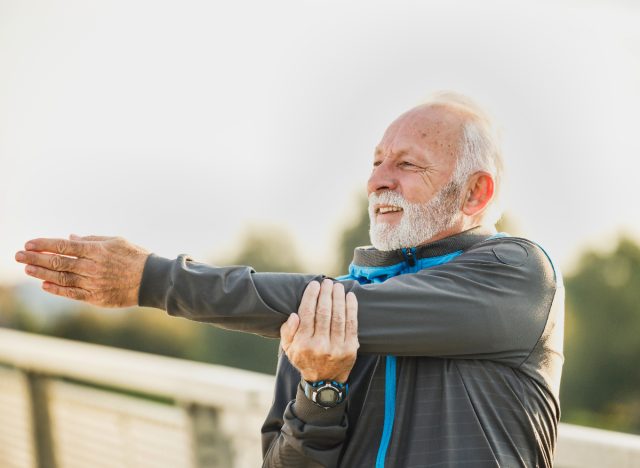 mature man stretching outdoors