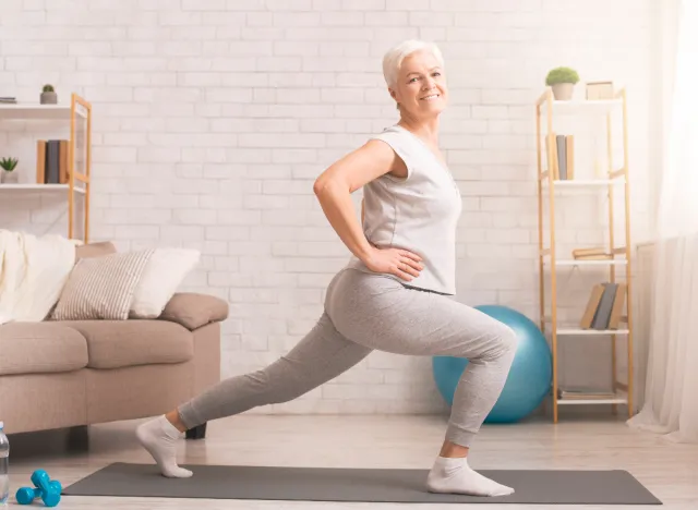 mature woman doing split squat to reverse aging after 60