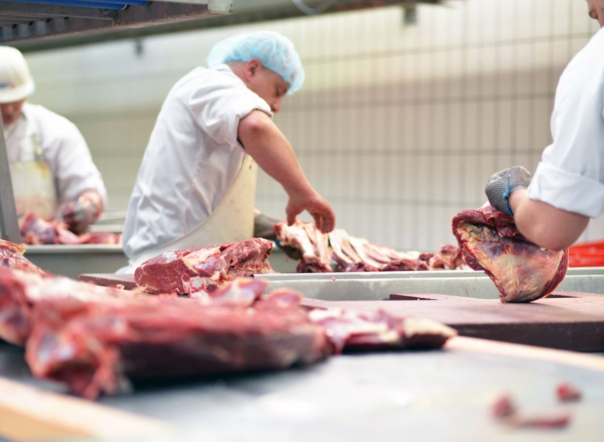 men working at a meat processing plant