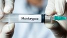 Male doctor holding monkeypox vaccine.