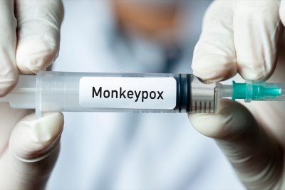 Male doctor holding monkeypox vaccine.