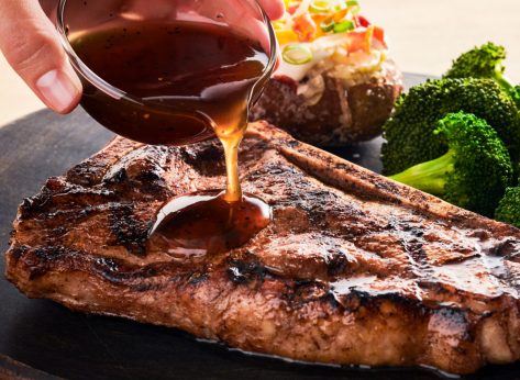 pouring sauce on outback steakhouse steak