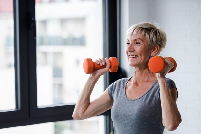 older woman lifting weights