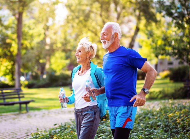older couple training 5k outdoors, jogging