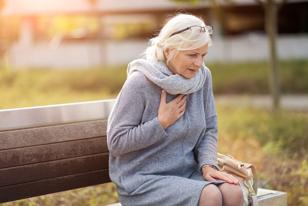 Senior,Woman,Suffering,From,Chest,Pain,While,Sitting,On,Bench