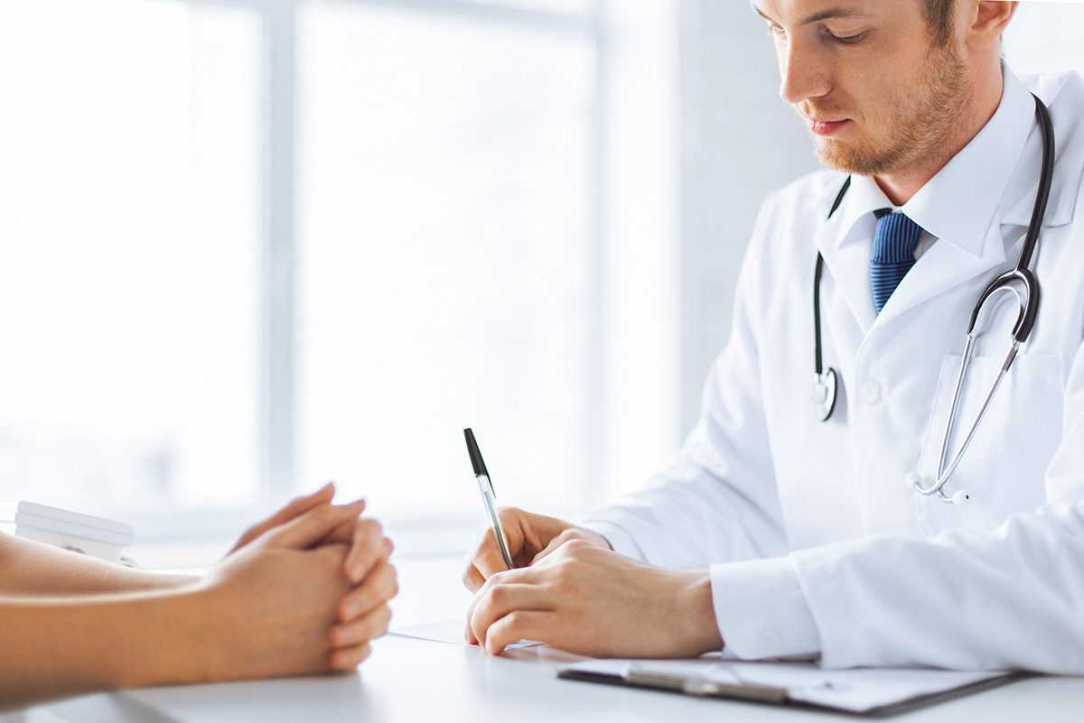 Close,Up,Of,Patient,And,Doctor,Taking,Notes