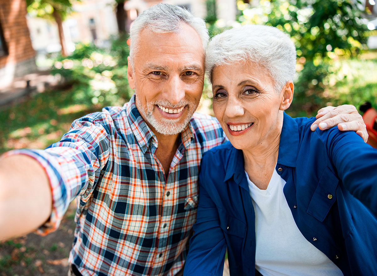 Elderly,Gentleman,Hugging,His,Charming,Wife,And,Smiling,Stock,Photo