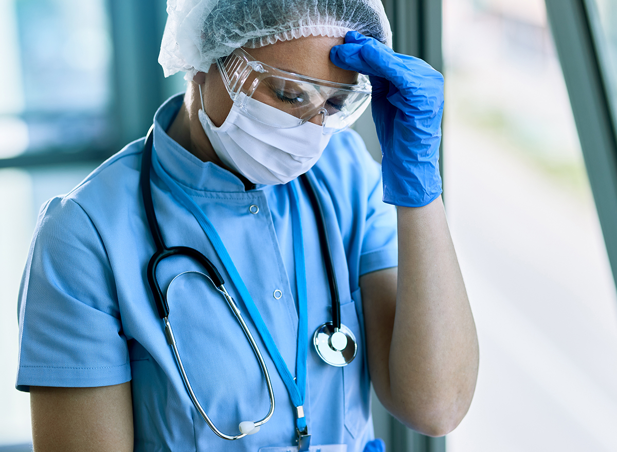 Exhausted,Female,Doctor,Having,Headache,While,Working,At,Clinic,During