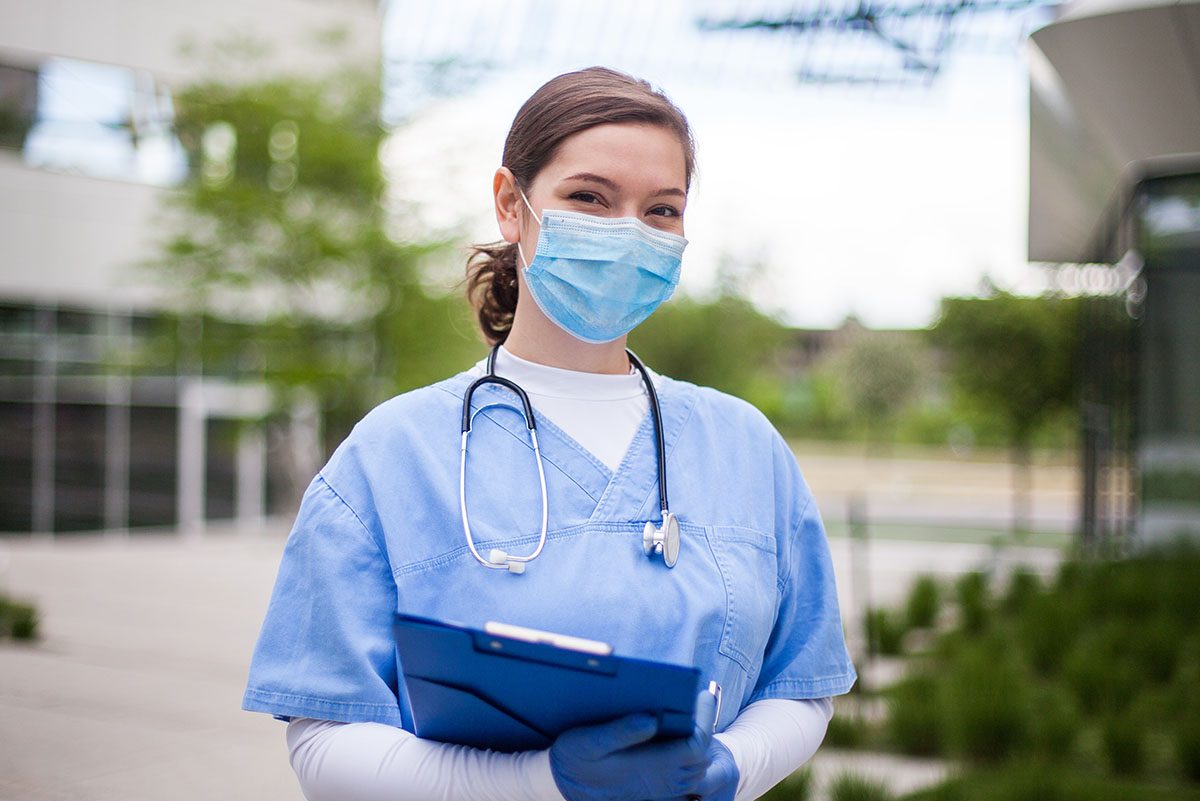 Female,Doctor,Holding,Blue,Clipboard,Standing,Outside,Hospital,Or,Clinic,frontline, Covid, mask, nurse