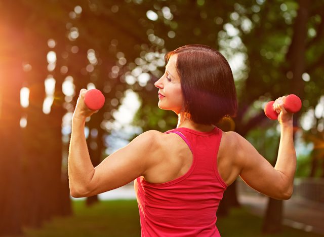 woman holding dumbbells