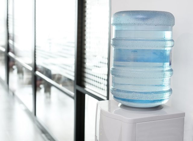 blue water gallon on electric water cooler in office area