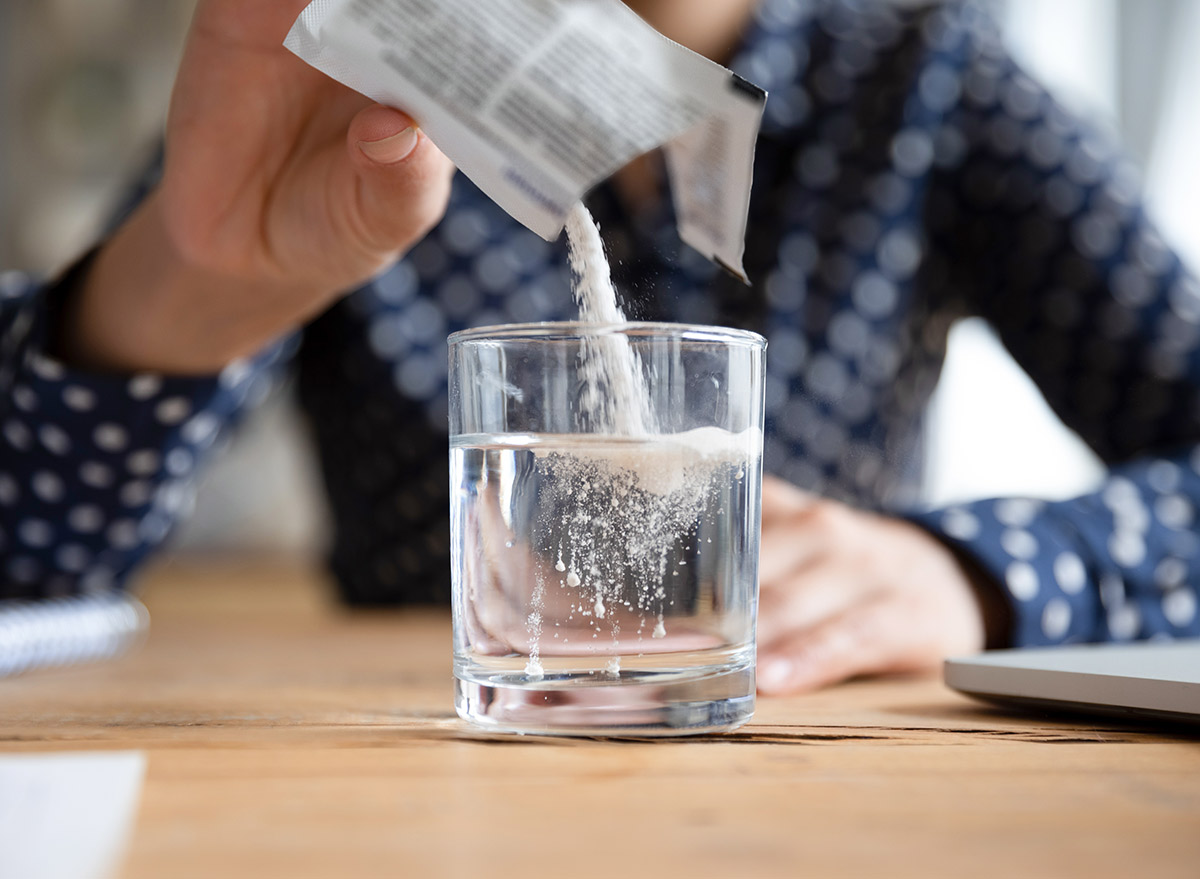 adding supplement to a glass of water