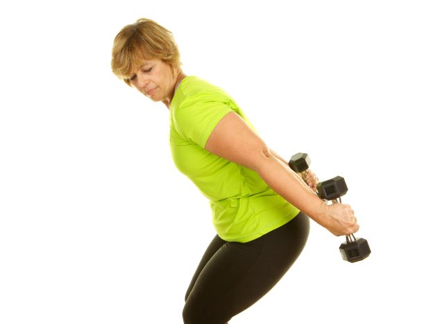 mature woman performing tricep kickback to get rid of arm jiggle