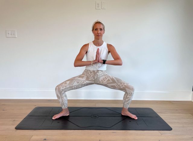 trainer demonstrating wide second squat