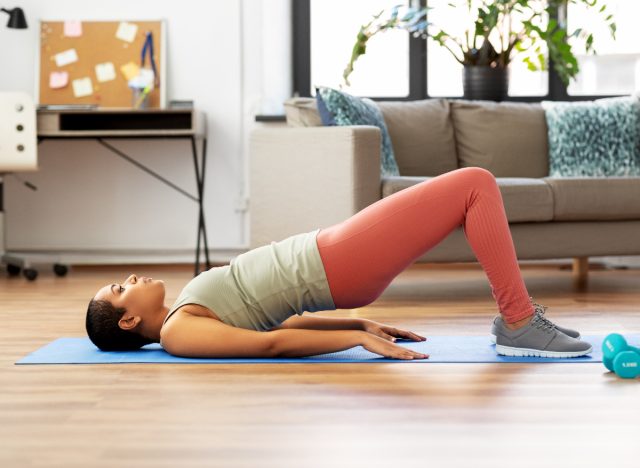 woman doing bridge exercise on yoga mat at home