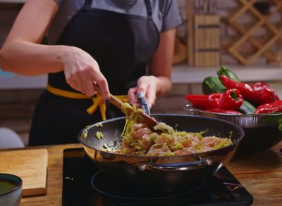 woman cooking chicken