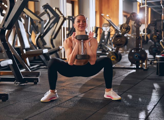 woman demonstrates goblet squat for those who want to get a lean body after 50