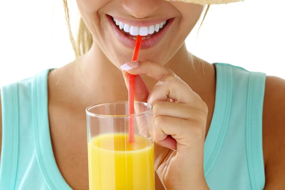 woman drinking orange juice