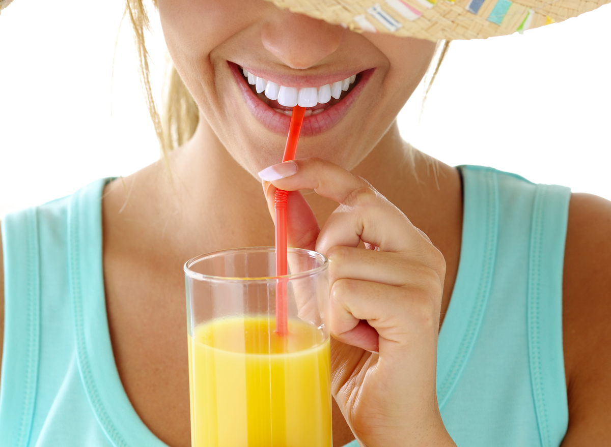 woman drinking orange juice